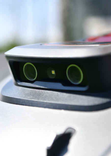 Robotic lawn mower adjusting to lawn slopes