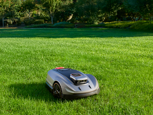 Sunseeker X5 robot lawn mower autonomously mowing a residential lawn