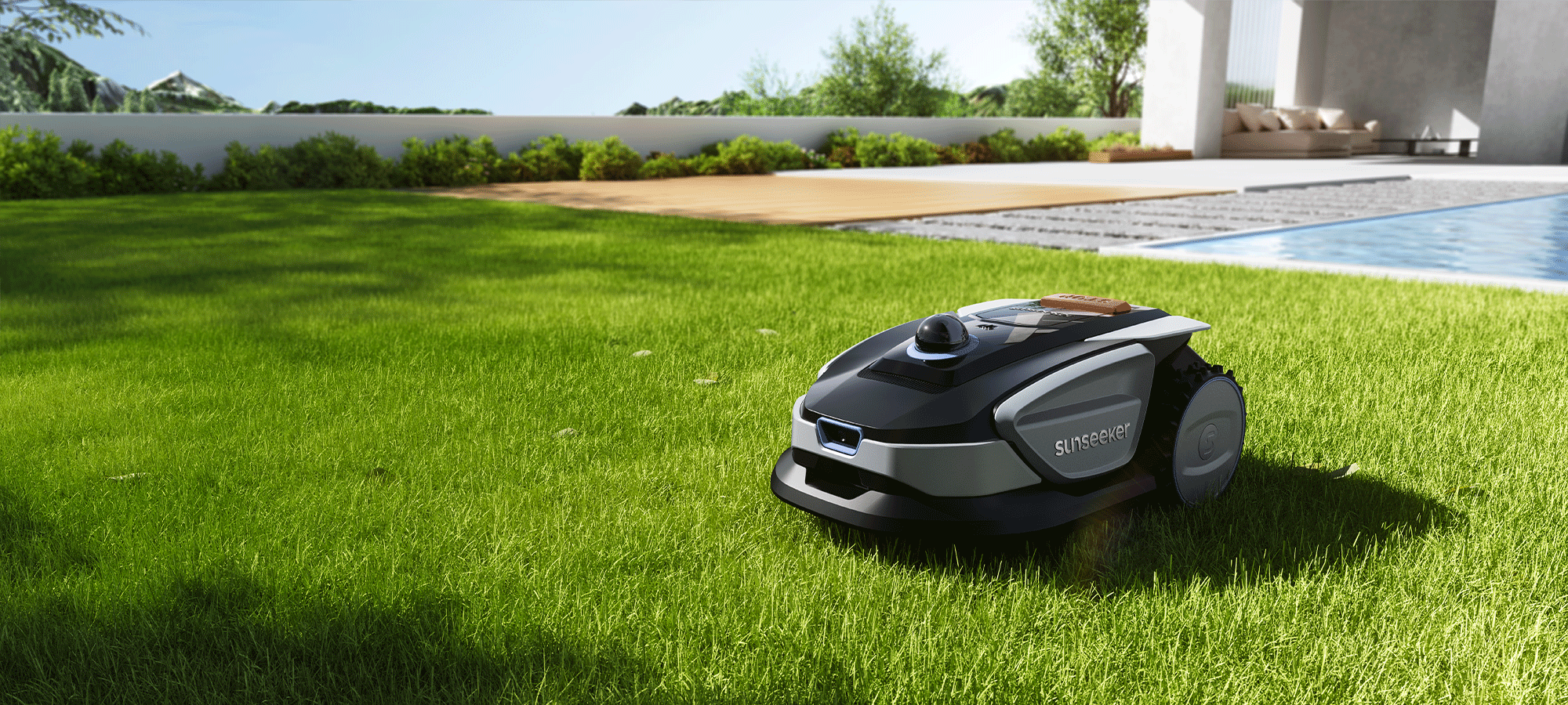 Robotic lawn mower on a grassy lawn with a pool and garden in the background