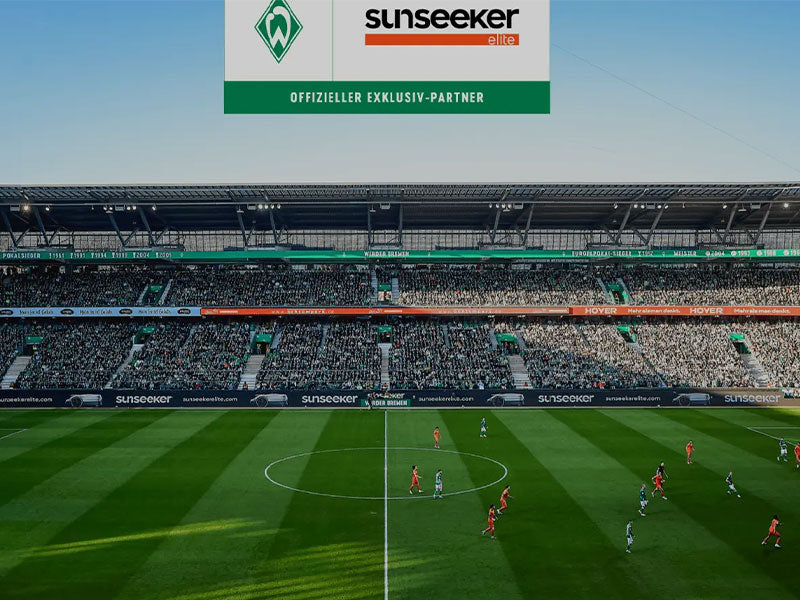 Soccer match in a stadium with 'sunseeker' logo displayed