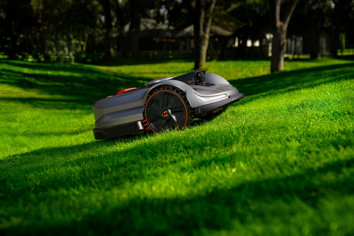 Sunseeker X7 Gen 2 mowing a grass slope, with a maximum slope rating of 70 percent or 35 degrees.